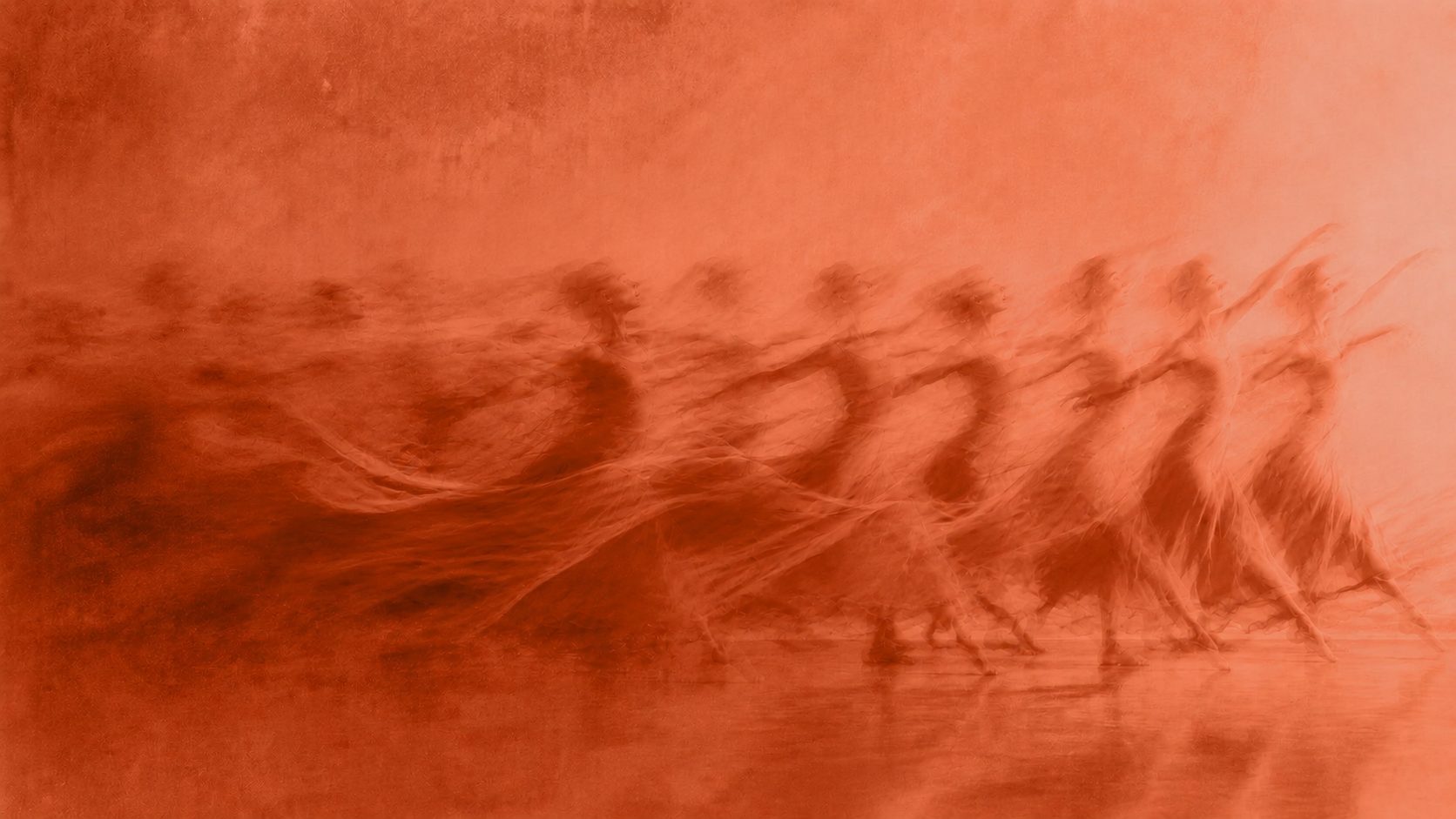 A line of dancers stepping forward in unison, captured with motion blur trailing behind them.